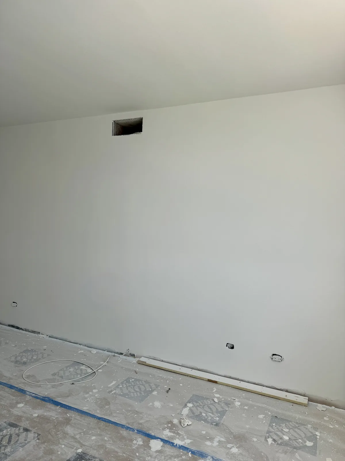 Same wall after wallpaper removal and wall repair, smooth and primed