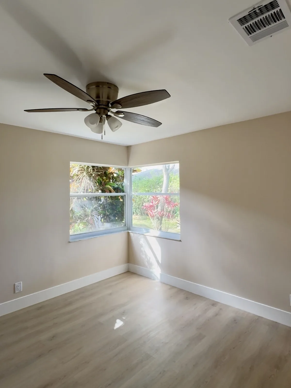 Same room after popcorn ceiling removal and wall repair, smooth finish
